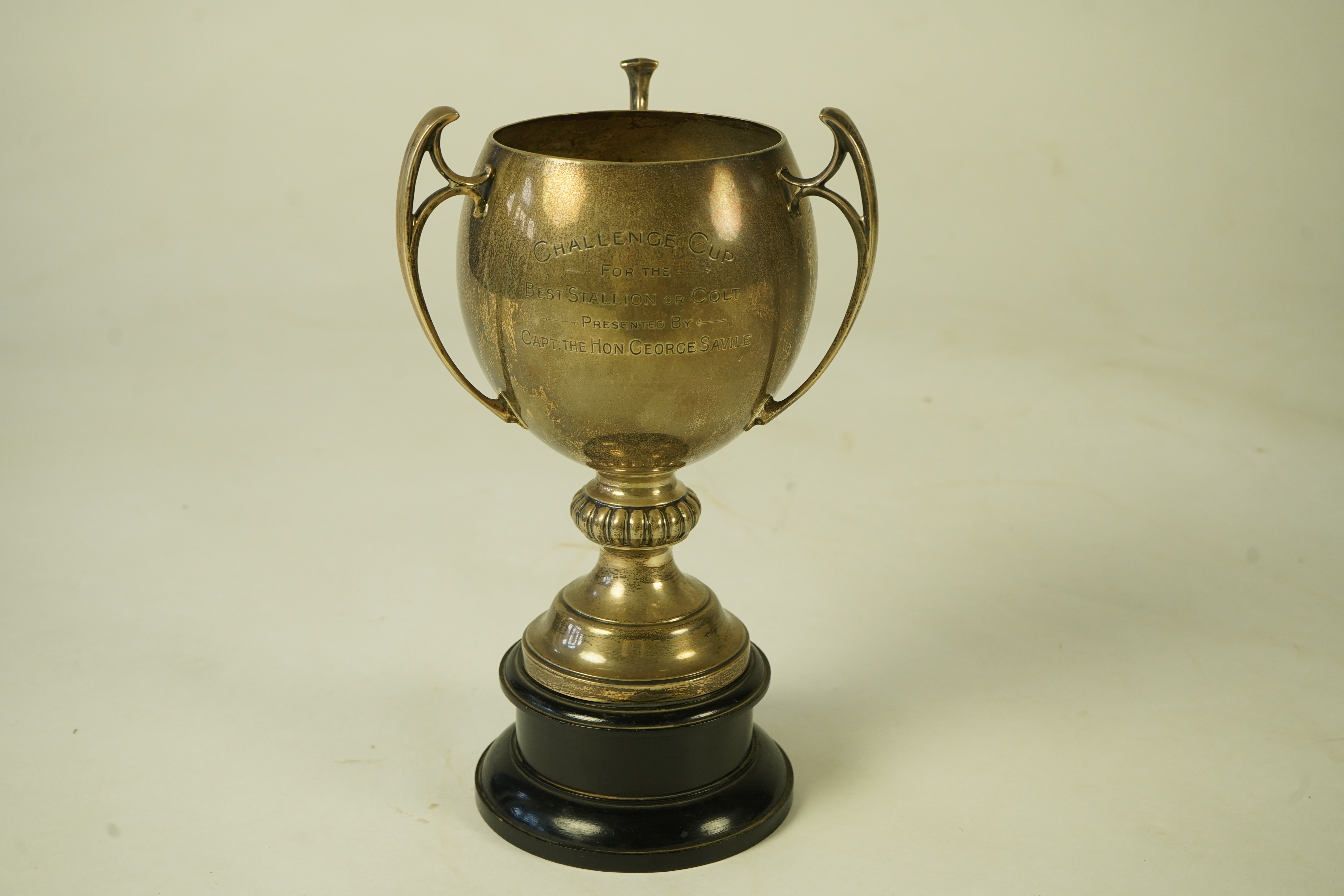 A George V silver tri-handled presentation pedestal trophy cup, with engraved horse racing inscription relating to 'The Arab Horse Society Challenge Cup for the Best Stallion or Colt'